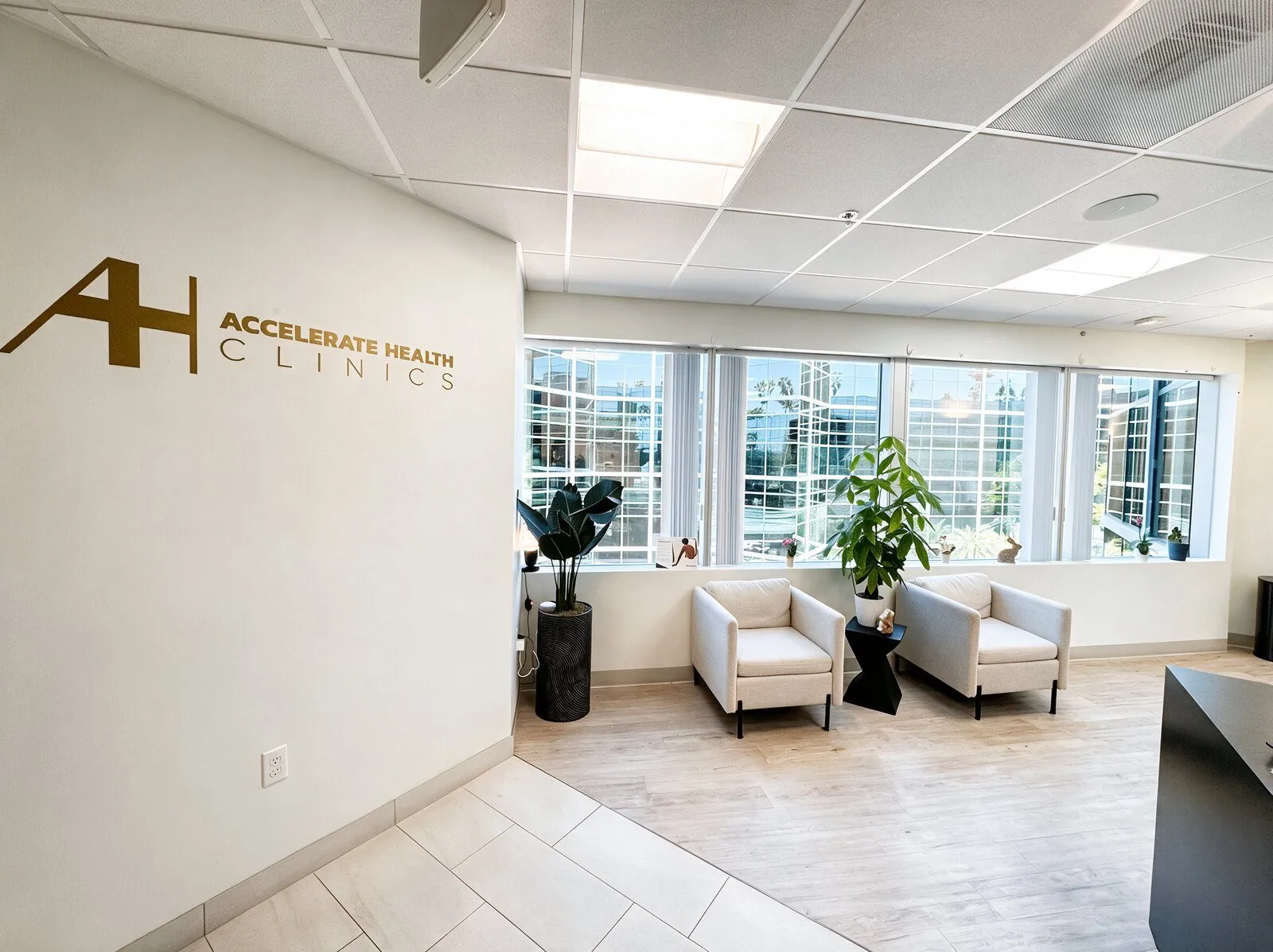 Waiting area at AH Clinics, with the Accelerate Health Clinics sign on the wall